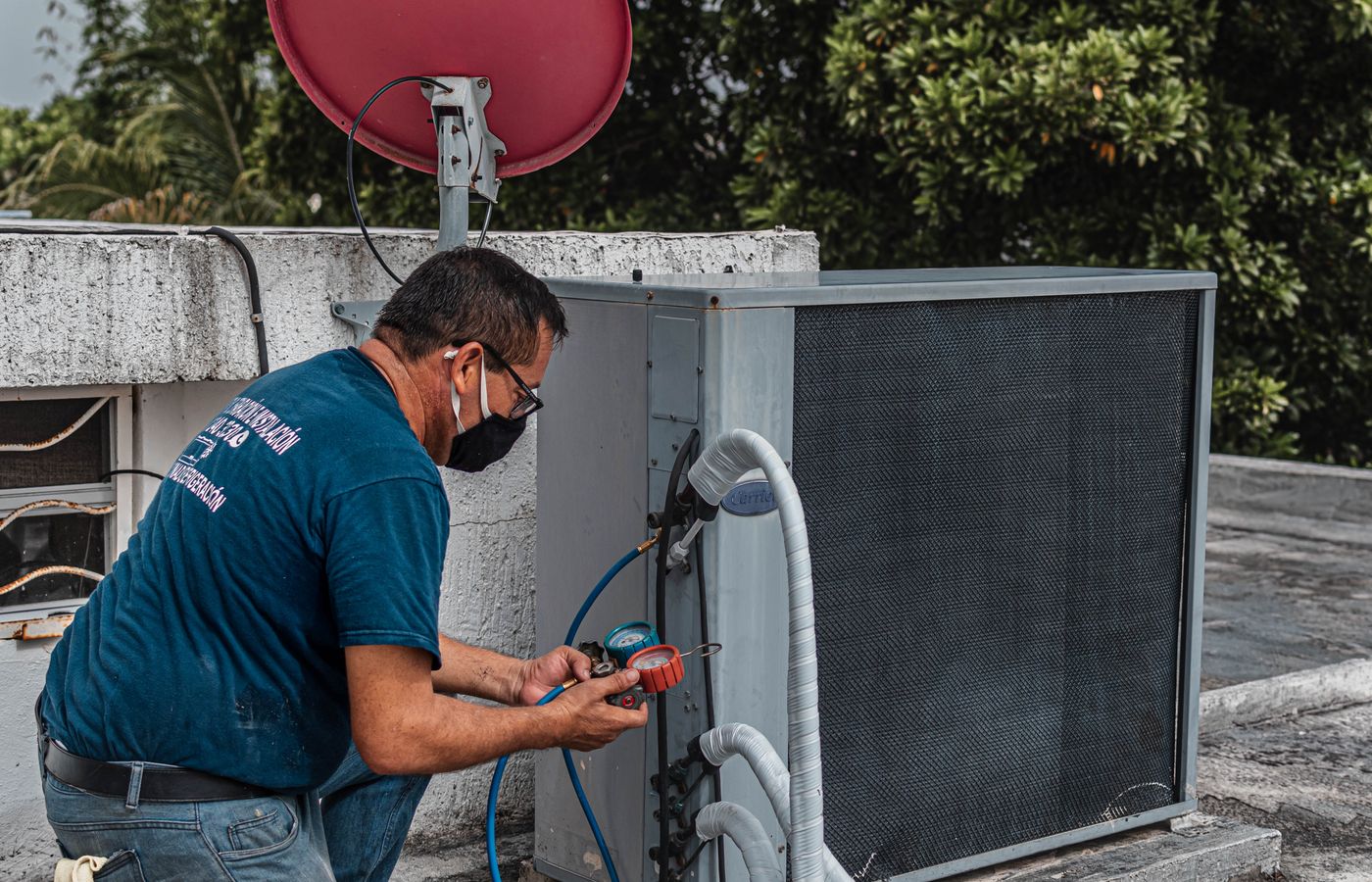HVAC technician servicing an air conditioning unit — 20-person HVAC company case study
